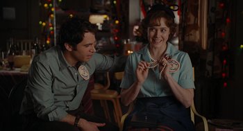 Movie still from “Julie & Julia” (2009), directed by Nora Ephron – A man and a woman sitting next to each other in a room; Close Up shot, Over the shoulder angle