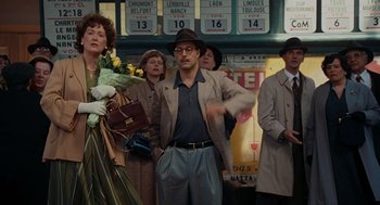 Movie still from “Julie & Julia” (2009), directed by Nora Ephron – A group of people standing in front of a building; Wide shot, Over the shoulder angle