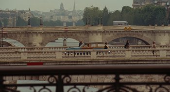 Movie still from “Julie & Julia” (2009), directed by Nora Ephron – A car is driving on a bridge over a body of water; Extreme Wide shot, Over the shoulder angle