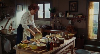 Movie still from “Julie & Julia” (2009), directed by Nora Ephron – A woman is preparing food in a kitchen; Wide shot, High angle