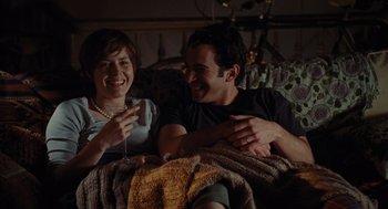 Movie still from “Julie & Julia” (2009), directed by Nora Ephron – A man and a woman sitting on a couch; Medium shot, Over the shoulder angle