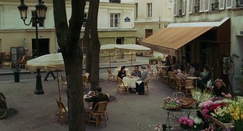 Movie still from “Julie & Julia” (2009), directed by Nora Ephron – A group of people sitting at a table outside; Extreme Wide shot, High angle