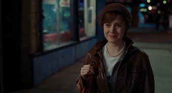 Movie still from “Julie & Julia” (2009), directed by Nora Ephron – A woman in a brown jacket holding a pink purse; Medium shot, Over the shoulder angle