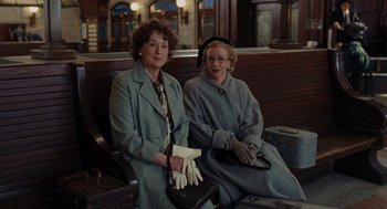 Movie still from “Julie & Julia” (2009), directed by Nora Ephron – Two women sitting next to each other on a bench; Medium shot, Over the shoulder angle