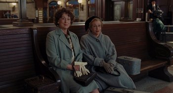 Movie still from “Julie & Julia” (2009), directed by Nora Ephron – Two women sitting next to each other on a bench; Medium shot, Over the shoulder angle