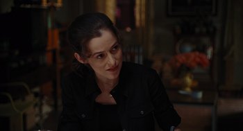 Movie still from “Julie & Julia” (2009), directed by Nora Ephron – A woman in a black shirt sitting in a room; Close Up shot, Over the shoulder angle