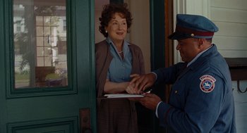 Movie still from “Julie & Julia” (2009), directed by Nora Ephron – An older woman standing in front of a door with an older man; Medium shot, Over the shoulder angle