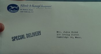 Movie still from “Julie & Julia” (2009), directed by Nora Ephron – An envelope that has some writing on it; Extreme Close Up shot, Overhead angle