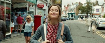 Movie still from “Juliet, Naked” (2018), directed by Jesse Peretz – A woman standing on the side of the street; Medium shot, Low angle