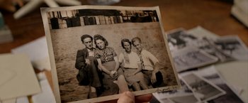 Movie still from “Juliet, Naked” (2018), directed by Jesse Peretz – An old photo of a group of people posing for a picture; Extreme Close Up shot, High angle
