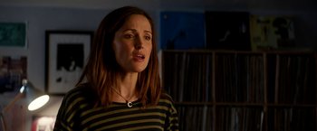 Movie still from “Juliet, Naked” (2018), directed by Jesse Peretz – A woman standing in front of a bookshelf; Close Up shot, Low angle