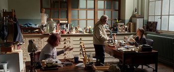 Movie still from “Juliet, Naked” (2018), directed by Jesse Peretz – A man and a woman working in an art studio; Wide shot, High angle