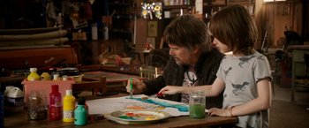 Movie still from “Juliet, Naked” (2018), directed by Jesse Peretz – A man and a woman painting on a paper; Medium shot, Over the shoulder angle