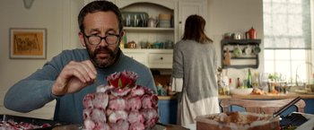 Movie still from “Juliet, Naked” (2018), directed by Jesse Peretz – A man and a woman in a kitchen looking at a cake; Medium shot, Over the shoulder angle