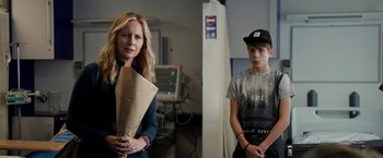Movie still from “Juliet, Naked” (2018), directed by Jesse Peretz – A woman and a boy standing in a hospital room; Medium shot, Over the shoulder angle