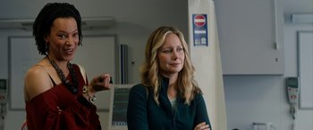 Movie still from “Juliet, Naked” (2018), directed by Jesse Peretz – A woman standing next to a man in a room; Medium shot, Over the shoulder angle