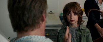 Movie still from “Juliet, Naked” (2018), directed by Jesse Peretz – A young boy is looking at his father in the mirror; Close Up shot, Over the shoulder angle
