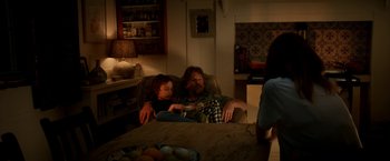 Movie still from “Juliet, Naked” (2018), directed by Jesse Peretz – A man and a child sitting on a couch; Medium shot, Over the shoulder angle