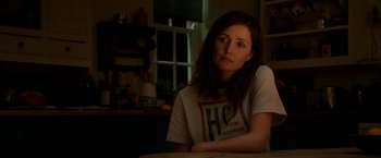 Movie still from “Juliet, Naked” (2018), directed by Jesse Peretz – A woman sitting at a table in front of a window; Close Up shot, Over the shoulder angle