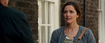 Movie still from “Juliet, Naked” (2018), directed by Jesse Peretz – A woman standing next to a brick building; Close Up shot, Over the shoulder angle