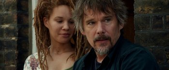 Movie still from “Juliet, Naked” (2018), directed by Jesse Peretz – A man and a woman standing next to each other; Close Up shot, Over the shoulder angle