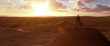 Movie still from “Jumper” (2008), directed by Doug Liman – A person standing on top of a sand dune; Extreme Wide shot, Low angle