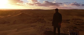 Movie still from “Jumper” (2008), directed by Doug Liman – A man standing on top of a hill looking at the sky; Extreme Wide shot, Over the shoulder angle