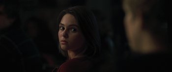 Movie still from “Jumper” (2008), directed by Doug Liman – A woman is looking into the distance in the dark; Close Up shot, Over the shoulder angle