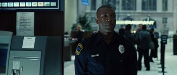 Movie still from “Jumper” (2008), directed by Doug Liman – A police officer is standing in an office building; Medium shot, Over the shoulder angle