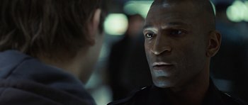 Movie still from “Jumper” (2008), directed by Doug Liman – A man's face in front of another man; Close Up shot, Over the shoulder angle