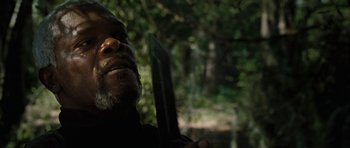Movie still from “Jumper” (2008), directed by Doug Liman – A person holding a knife in a forest; Close Up shot, Over the shoulder angle