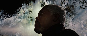 Movie still from “Jumper” (2008), directed by Doug Liman – A person with a beard looking up; Close Up shot, Low angle