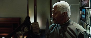 Movie still from “Jumper” (2008), directed by Doug Liman – An older man with white hair is standing in a room; Close Up shot, Over the shoulder angle