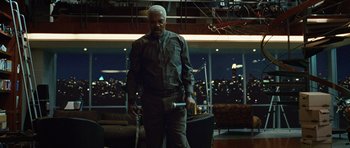 Movie still from “Jumper” (2008), directed by Doug Liman – An older man holding a walking stick in a living room; Medium shot, Low angle