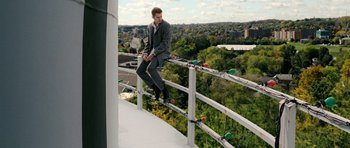 Movie still from “Jumper” (2008), directed by Doug Liman – A man standing on a railing on top of a building; Wide shot, Low angle