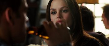 Movie still from “Jumper” (2008), directed by Doug Liman – A woman sitting at a table with a cigarette in her mouth; Close Up shot, Over the shoulder angle