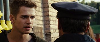 Movie still from “Jumper” (2008), directed by Doug Liman – A man in a police uniform talking to another man; Close Up shot, Over the shoulder angle