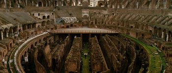 Movie still from “Jumper” (2008), directed by Doug Liman – An old building with a lot of grass in the middle of it; Extreme Wide shot, High angle
