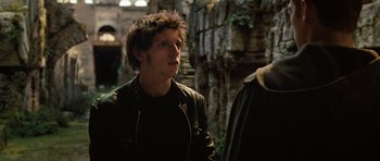Movie still from “Jumper” (2008), directed by Doug Liman – A man in a leather jacket standing next to another man; Close Up shot, Over the shoulder angle