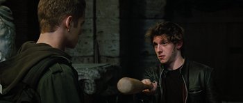 Movie still from “Jumper” (2008), directed by Doug Liman – A man holding a baseball bat while another man looks at him; Close Up shot, Over the shoulder angle