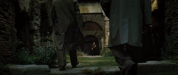 Movie still from “Jumper” (2008), directed by Doug Liman – A group of people walking on a path near a bridge; Extreme Wide shot, High angle