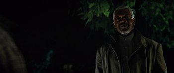 Movie still from “Jumper” (2008), directed by Doug Liman – A man standing in front of a tree at night; Close Up shot, Low angle