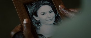 Movie still from “Jumper” (2008), directed by Doug Liman – A person holding a picture of a woman in a black and white photo; Extreme Close Up shot, High angle