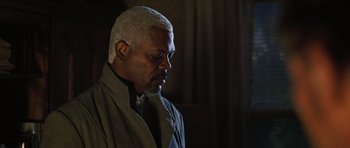 Movie still from “Jumper” (2008), directed by Doug Liman – An older man with white hair looking to his left; Close Up shot, Over the shoulder angle