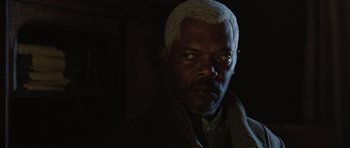 Movie still from “Jumper” (2008), directed by Doug Liman – A man with a white beard and a black jacket; Close Up shot, Over the shoulder angle