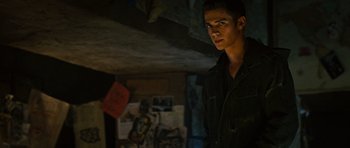 Movie still from “Jumper” (2008), directed by Doug Liman – A young man standing in a dark room; Medium shot, Over the shoulder angle