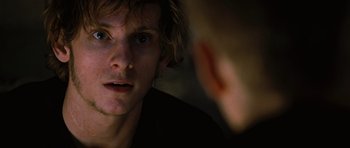 Movie still from “Jumper” (2008), directed by Doug Liman – A young man looking into a mirror while another looks on; Close Up shot, Over the shoulder angle