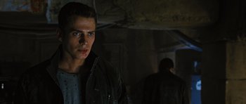 Movie still from “Jumper” (2008), directed by Doug Liman – A young man in a black jacket standing next to a wall; Close Up shot, Over the shoulder angle