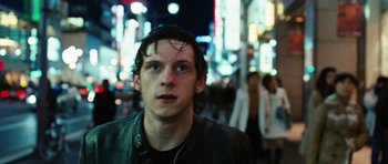 Movie still from “Jumper” (2008), directed by Doug Liman – A young man standing on a street at night; Close Up shot, Low angle