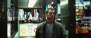 Movie still from “Jumper” (2008), directed by Doug Liman – A man standing in front of a building at night; Close Up shot, Low angle